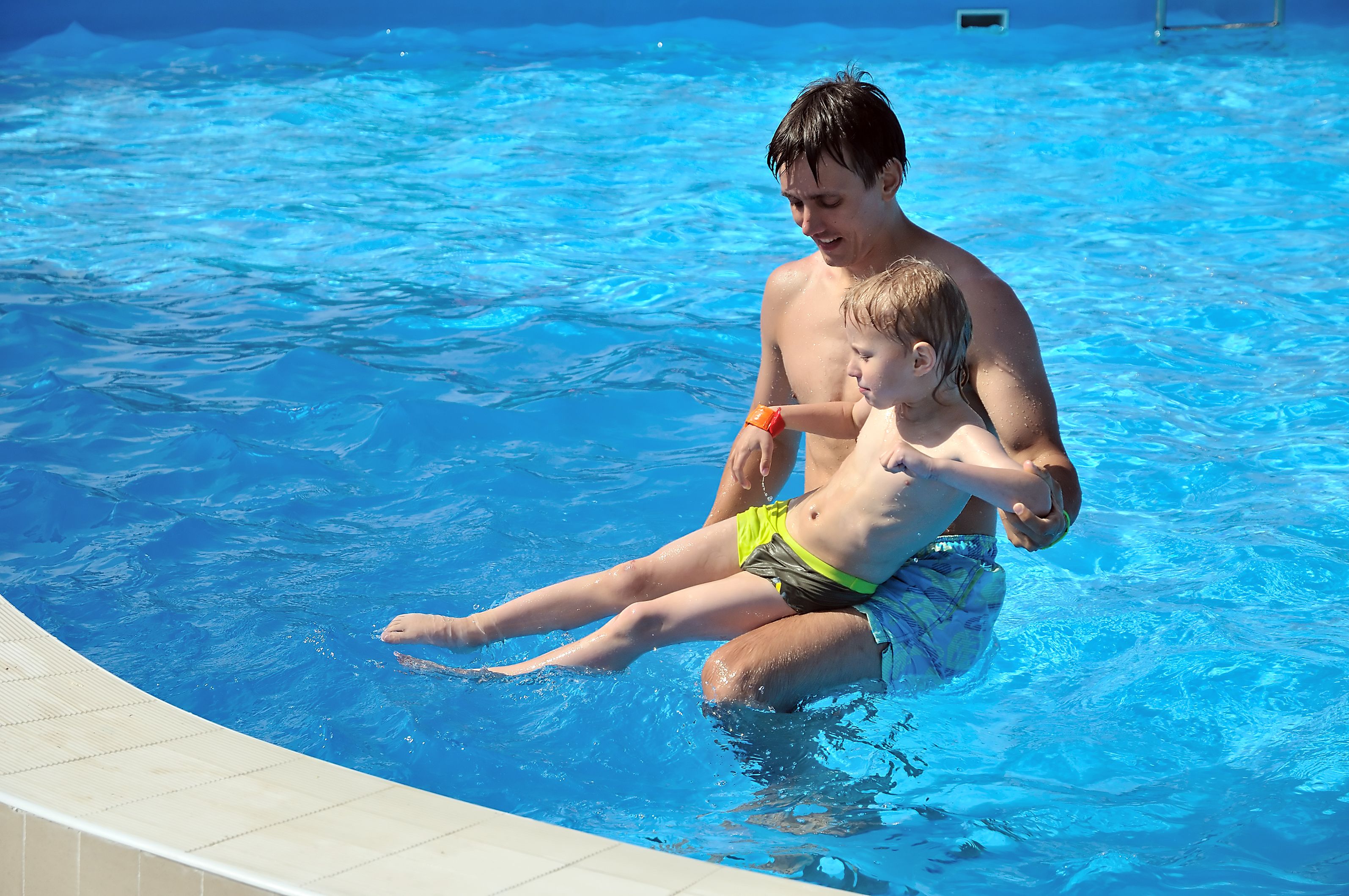 Father teaching his autistic child to swim