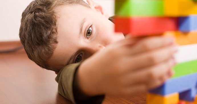 Boy with autism playing with blocks