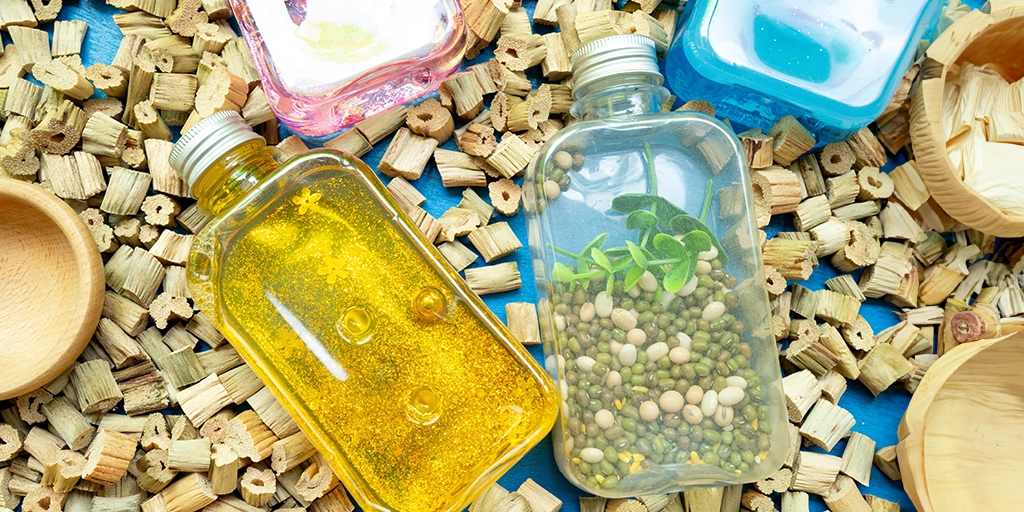 A collection of bottles, arranged for indoor winter sensory activities for autistic children.