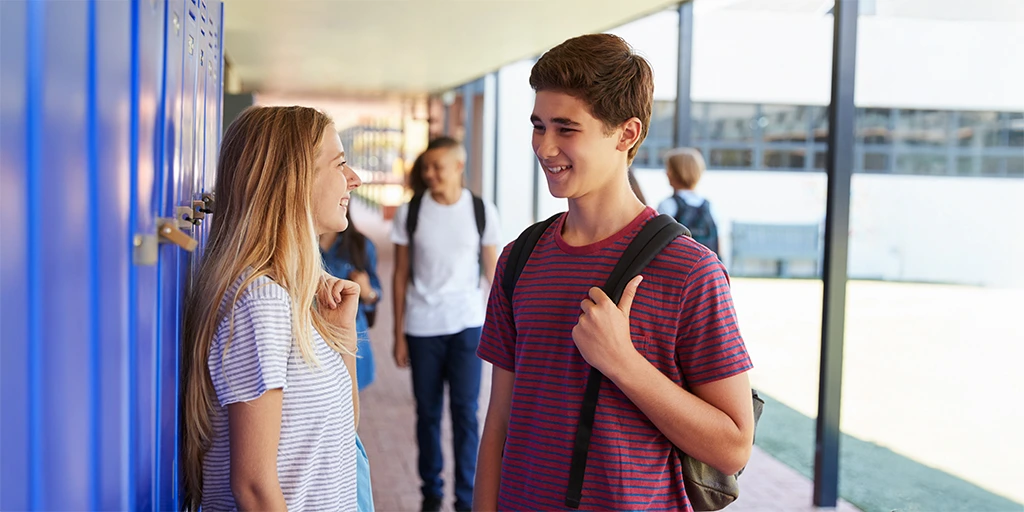 Teenagers socializing at school lockers, representing the challenges and milestones of adolescence with autism.